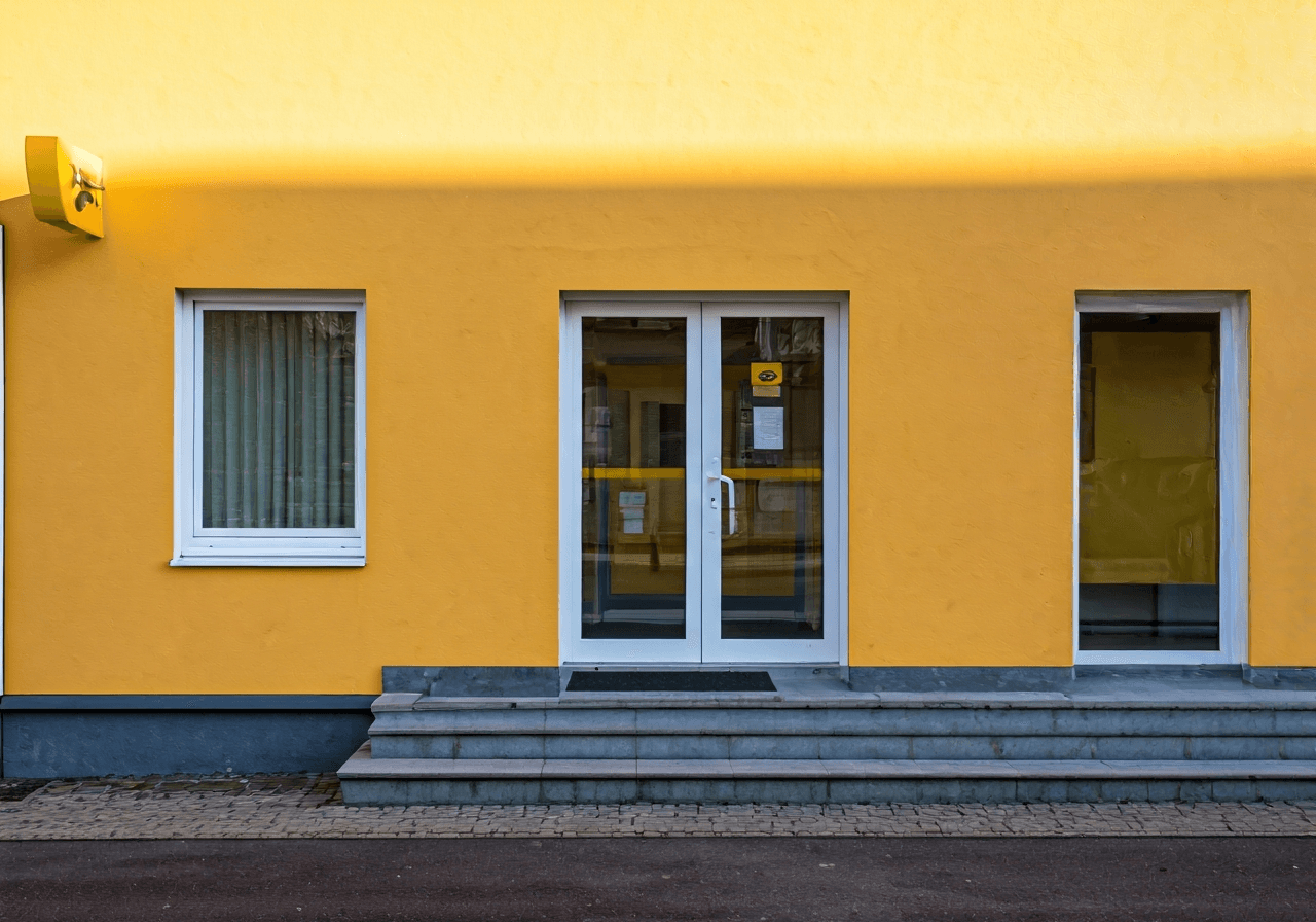 Pošta Veverská Bítýška: Rychlý návod (Otevírací doba 2026) 2 A modern and clean exterior shot of a local post office service point in a small Czech town, warm and inviting atmosphere, editorial photography, soft natural light, 85mm lens, highly detailed, no text, no letters