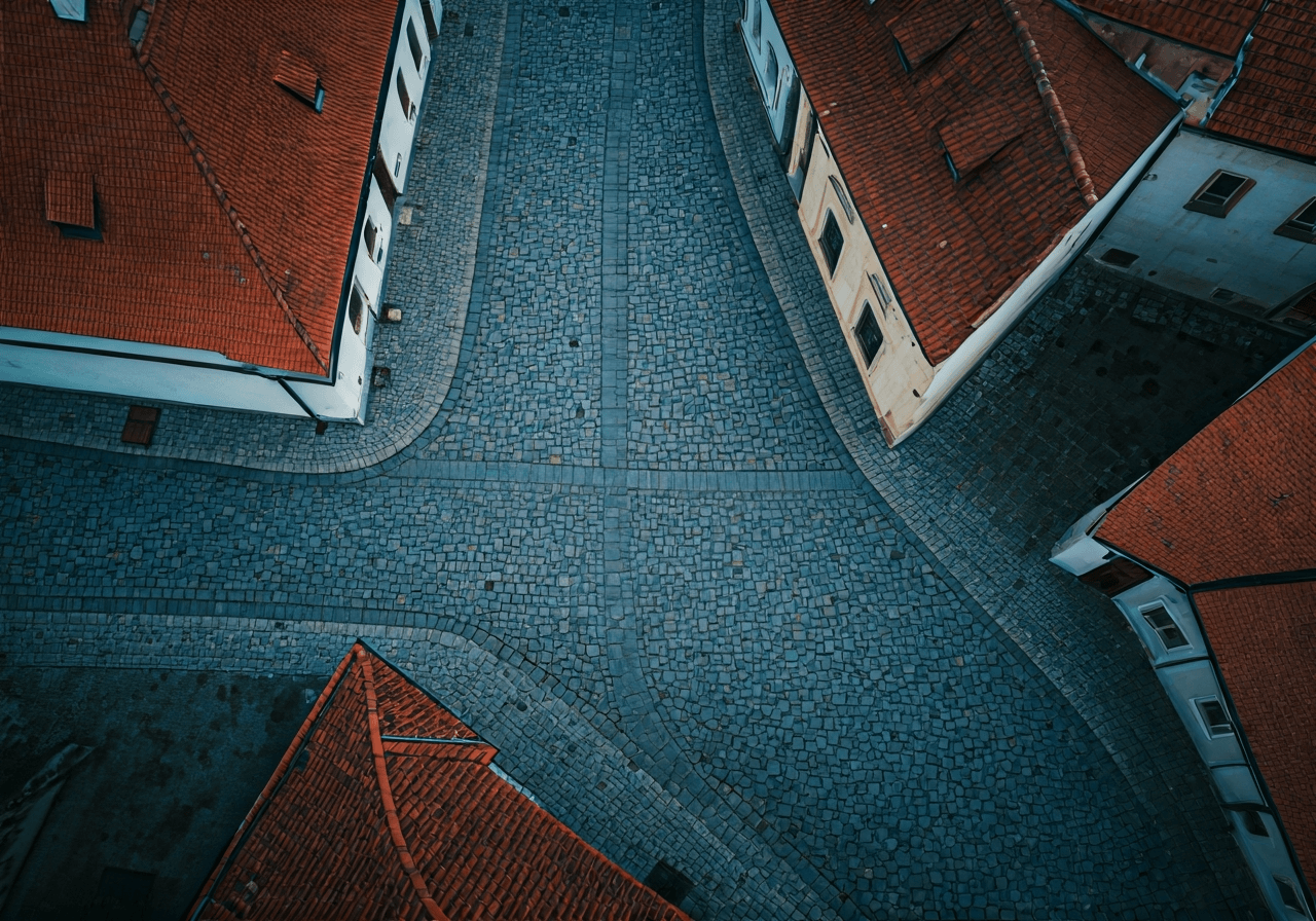 Aerial view of historical street layouts in a Czech town, cobblestone paths and heritage architecture, modern clean aesthetic, soft natural light, 85mm lens, highly detailed, no text, no words, no letters