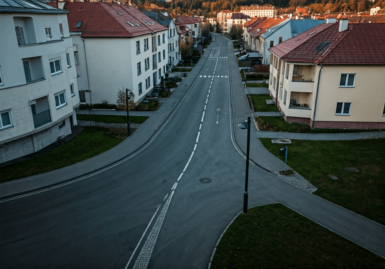 Aerial view of a clean residential street in a Czech town, modern aesthetic, soft natural light, 85mm lens, highly detailed, professional editorial photography, no text, no words, no letters