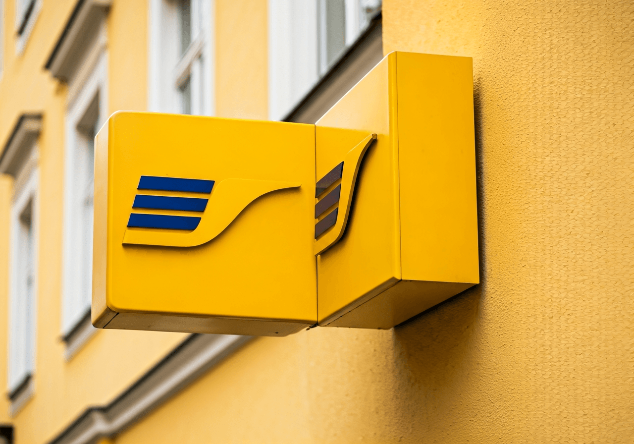 Pošta Stříbro: Funguje spolehlivě? (Velký test) 1 Editorial photography, modern signage of a Czech post office branch in a historic European town, bright daylight, cinematic depth of field, 85mm lens, high quality, no text, no letters