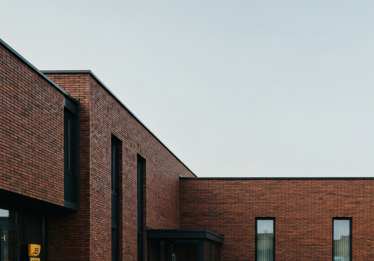 A professional exterior shot of a modern Czech post office branch, clean architectural lines, brick facade, soft natural daylight, cinematic depth of field, 85mm lens, high quality editorial photography, no text, no letters