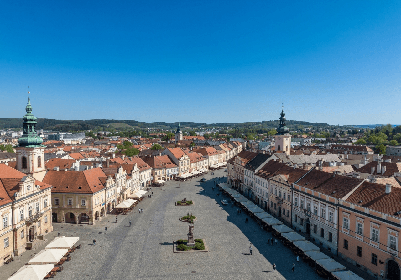 Aerial view of the historical town square in Krnov, Moravian-Silesian region, clean blue sky, editorial urban photography, bright natural daylight, 85mm lens, high resolution, no text, no words, no letters