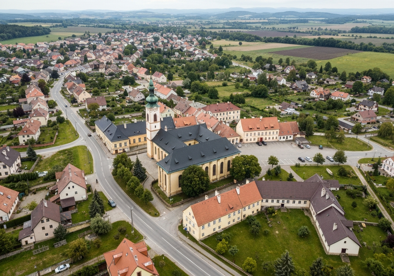 Aerial view of the town of Protivin in the Czech Republic, historic architecture with winding roads, lush South Bohemian countryside, editorial photography, cinematic lighting, 85mm lens, high detail, no text, no letters